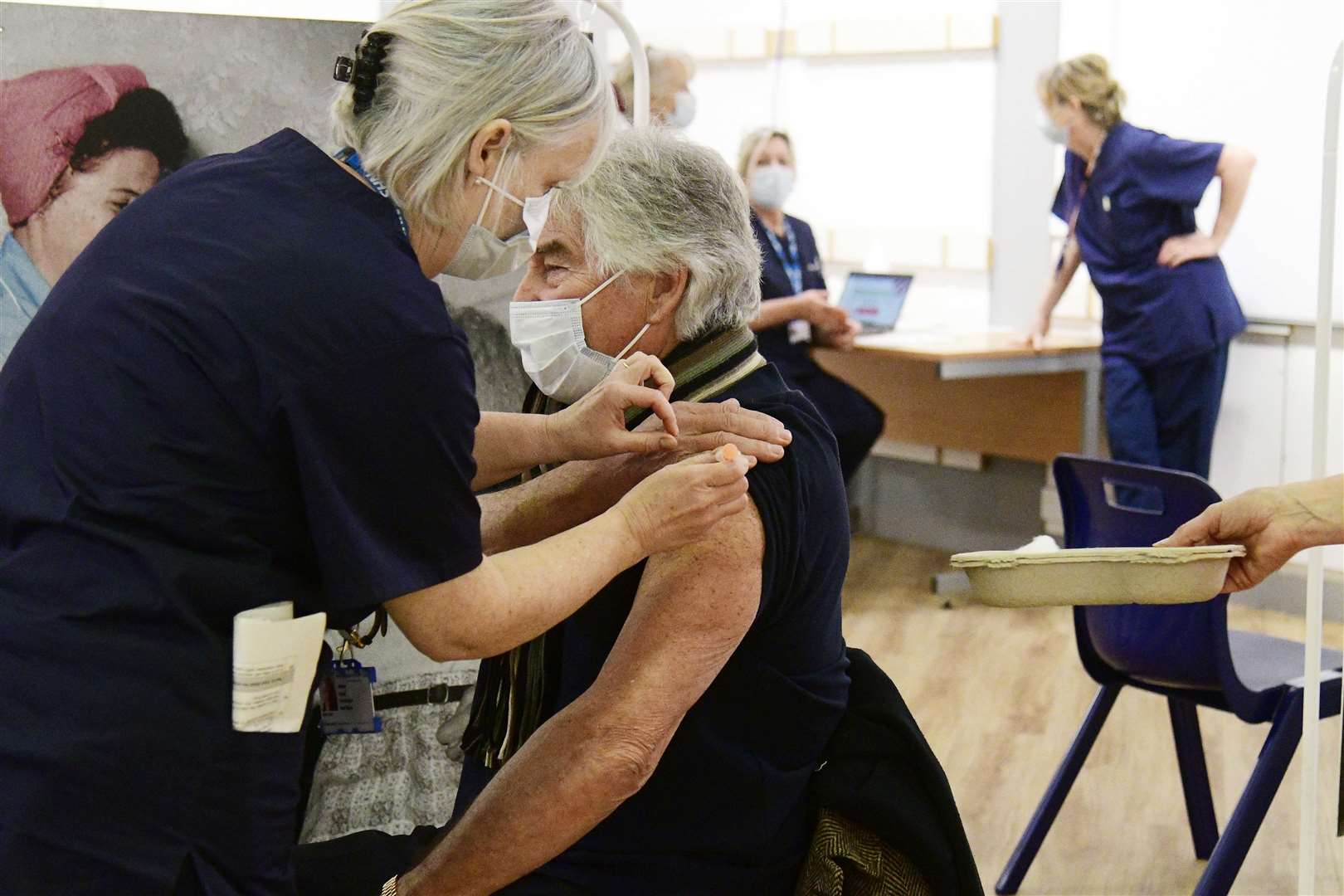 Richard Collins, receives his Covid-19 vaccination, at the first mass vaccine centre in Kent at the former Debenhams store in Folkestone. Picture: Barry Goodwin