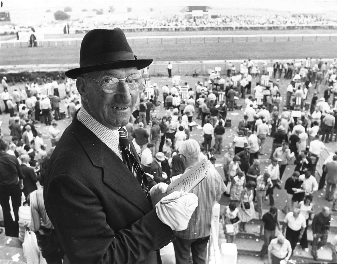A bookie studies the form at Folkestone Racecourse in 1976