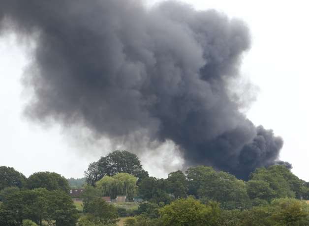 A large plume of black smoke can be seen from a considerable distance away