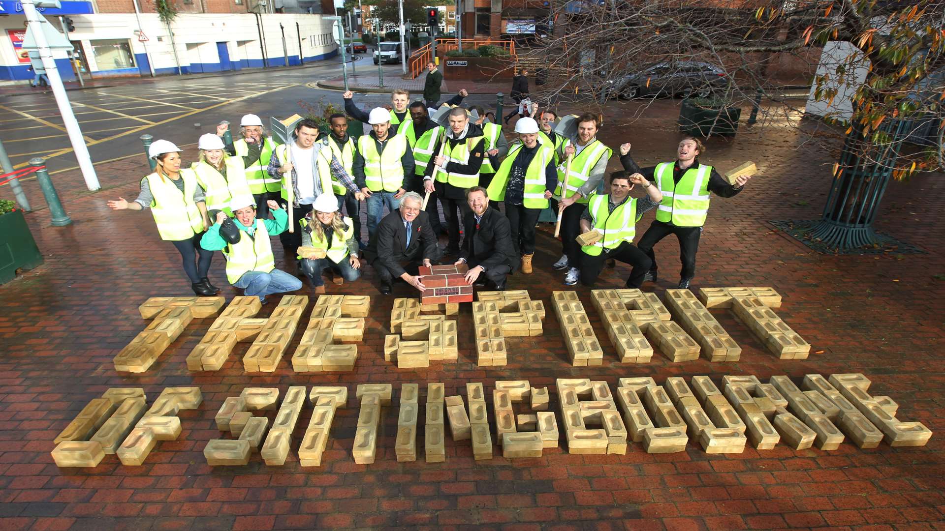 Cllr Mike Cosgrove, Rob Sloper, development director of the Cathedral Group, and a group of bricklayers outside Swale House