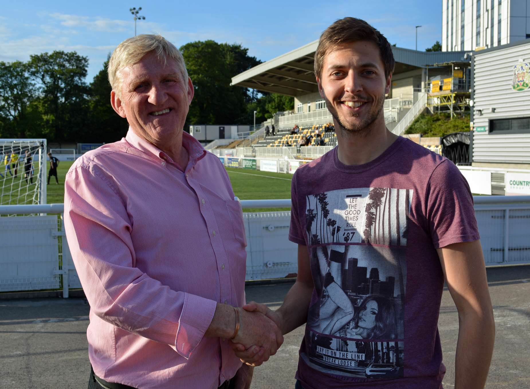 Co-owner Terry Casey welcomes new signing Joe Healy to Maidstone United