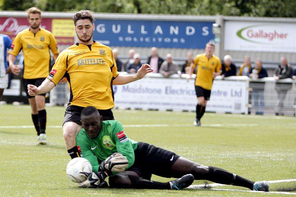 Maidstone's Alex Brown tries to get to the ball ahead of Grays keeper George Kamurasi. Picture: Matthew Walker