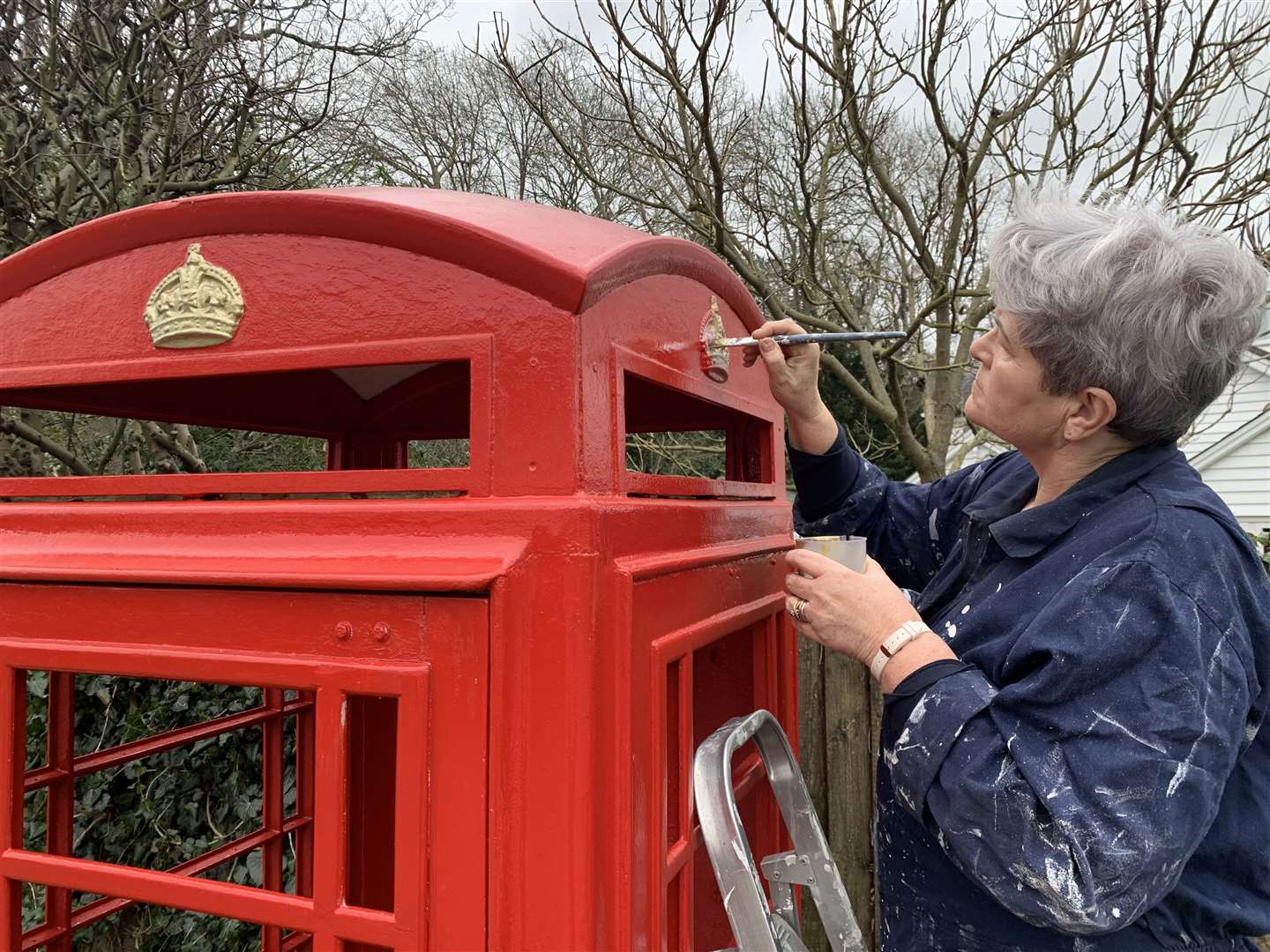 Denise Curtain, Chair of Rolvenden Parish Council painting the gold crowns. Picture: The Rolvenden Layne Sound Museum