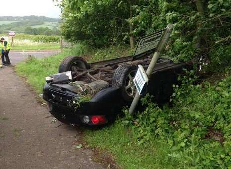 The car overturned on the A26 and hit a bus stop sign. Picture: @roadpol_east