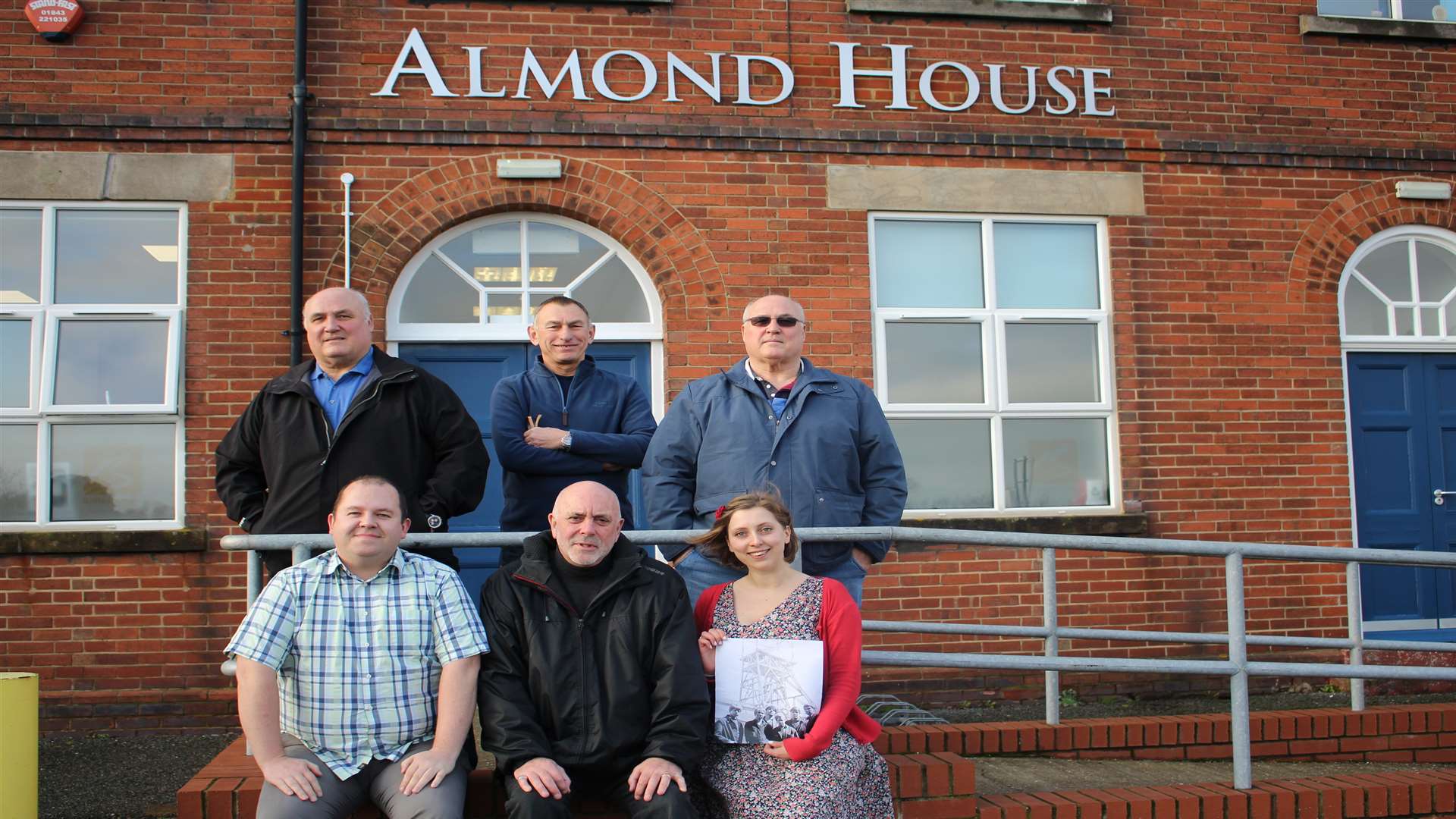 Reunion at Almond House, Betteshanger. (Back row (L-R): Andrew Inglis (ex-miner), Brian Hood (ex-miner), John Inglis (ex-miner). Front row (L-R): Darran Cowd (Museum and Heritage Manager, Kent Mining Museum; Mike Dugdale (photographer), Madeline Outen (Community Curator, Kent Mining Museum).
