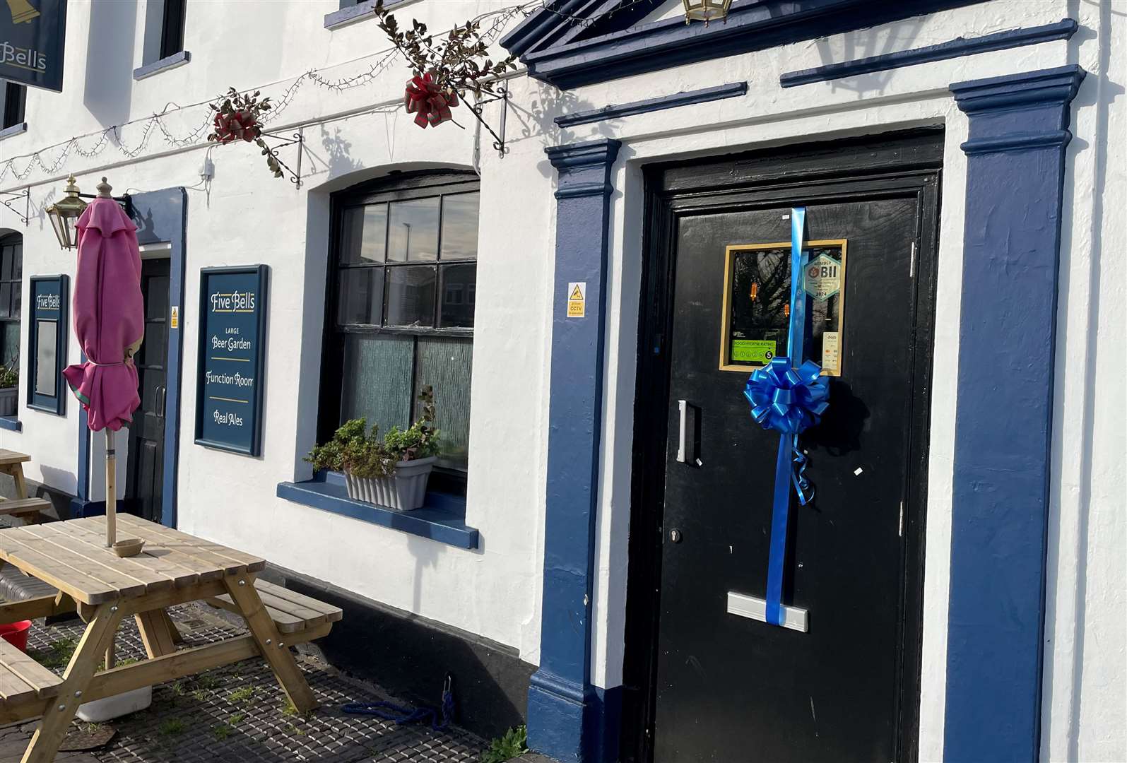A blue ribbon was tied to the door of the Five Bells pub for Liam Graham's funeral on Friday