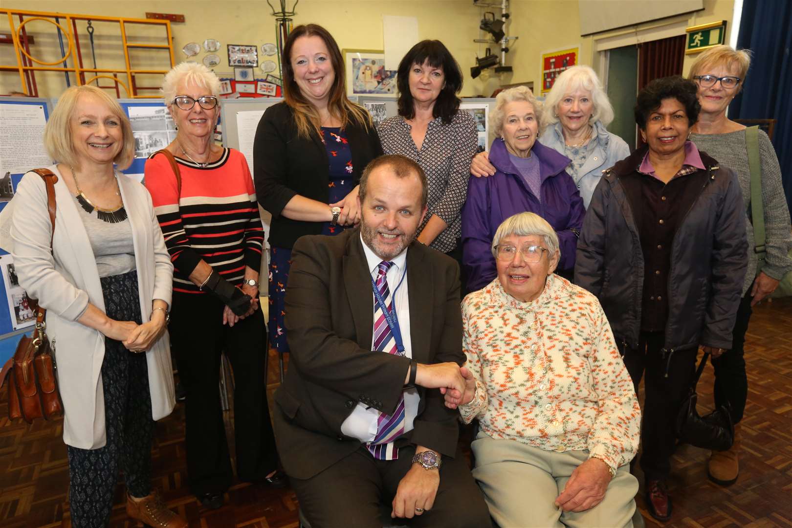 Head teacher Ryan Driver with Madge Borner, who taught at the school between 1947-1988, Lindsay Fordyce, deputy head, directly behind Ryan plus other former and current staff
