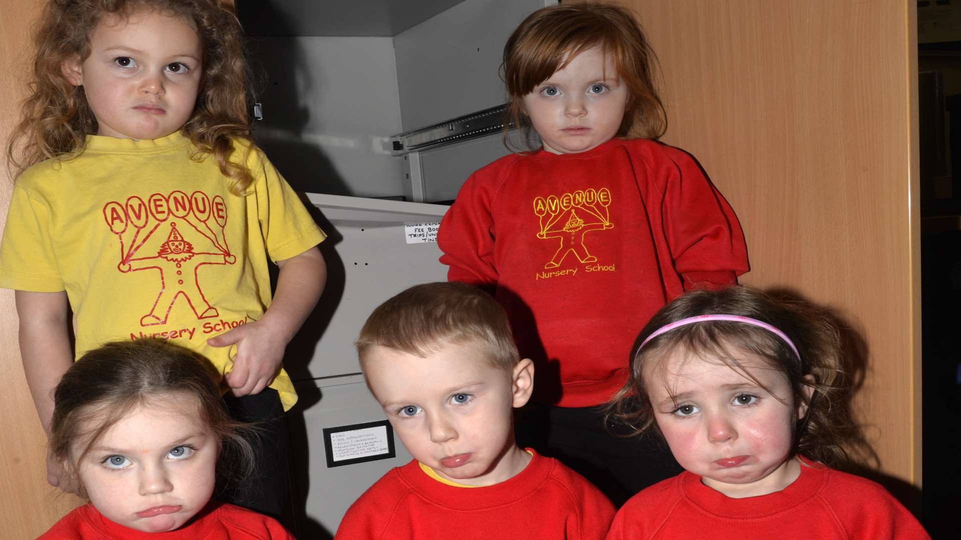 Tilly, 4, Rebecca, 4, Aaliyah, 3, Harrison, 4, and Jessica, 3, in front of the cupboard that was broken into