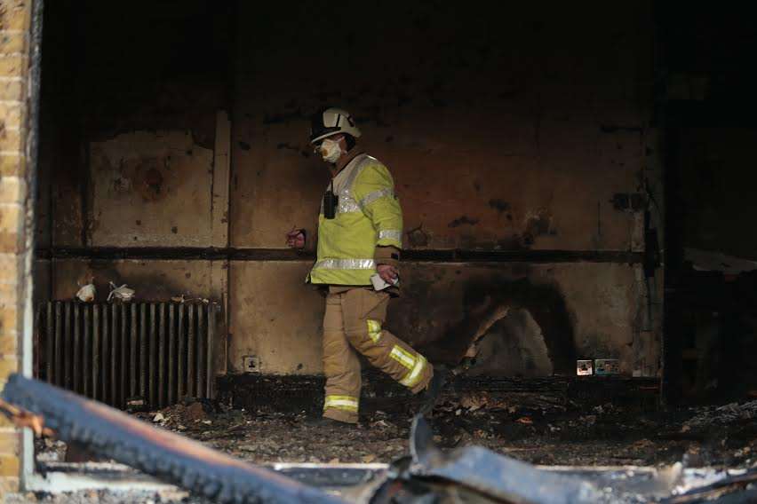 A firefighter inspects the damage. Picture: Martin Apps
