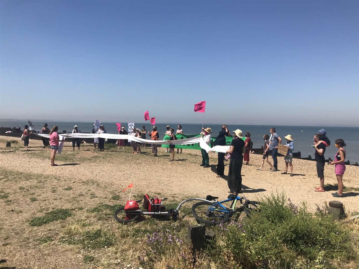 Protestors from Whitstable XR gather on the beach. Picture: Bernadette Fisher / Twitter