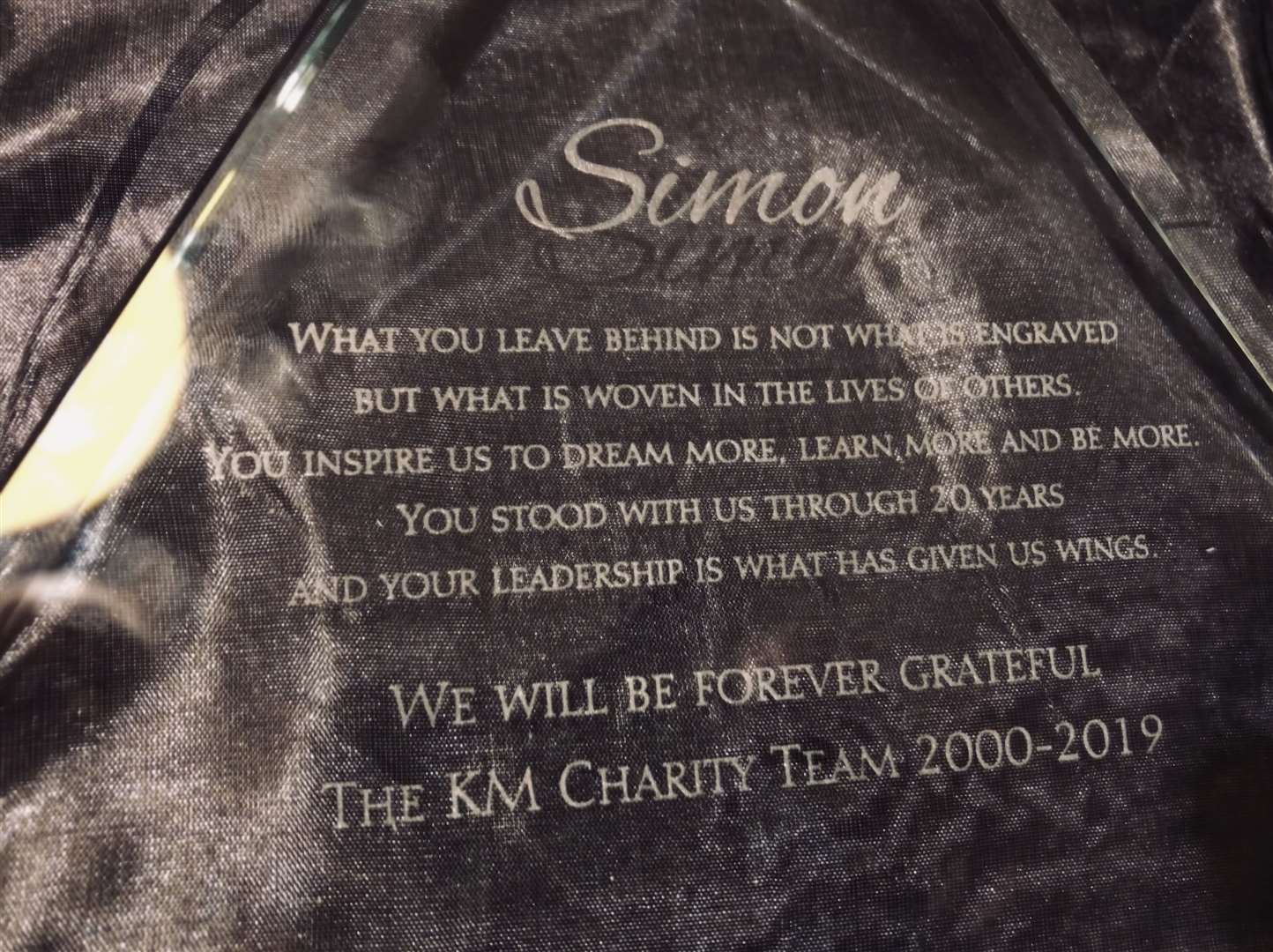 KM Charity Team staff presented outgoing CEO Simon Dolby with an engraved trophy. (16213957)