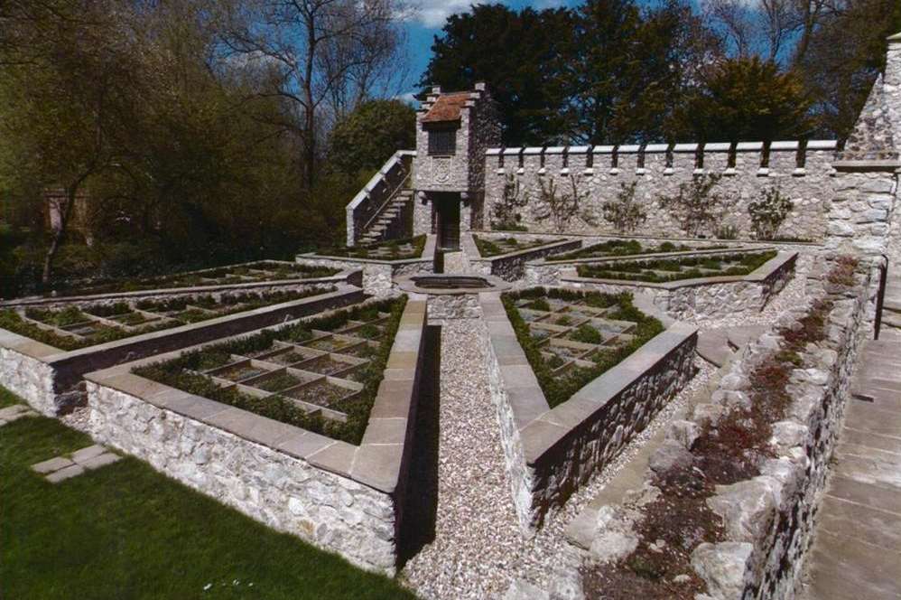 The turreted wall and raised beds in the garden of Jools Holland's Cooling Castle home