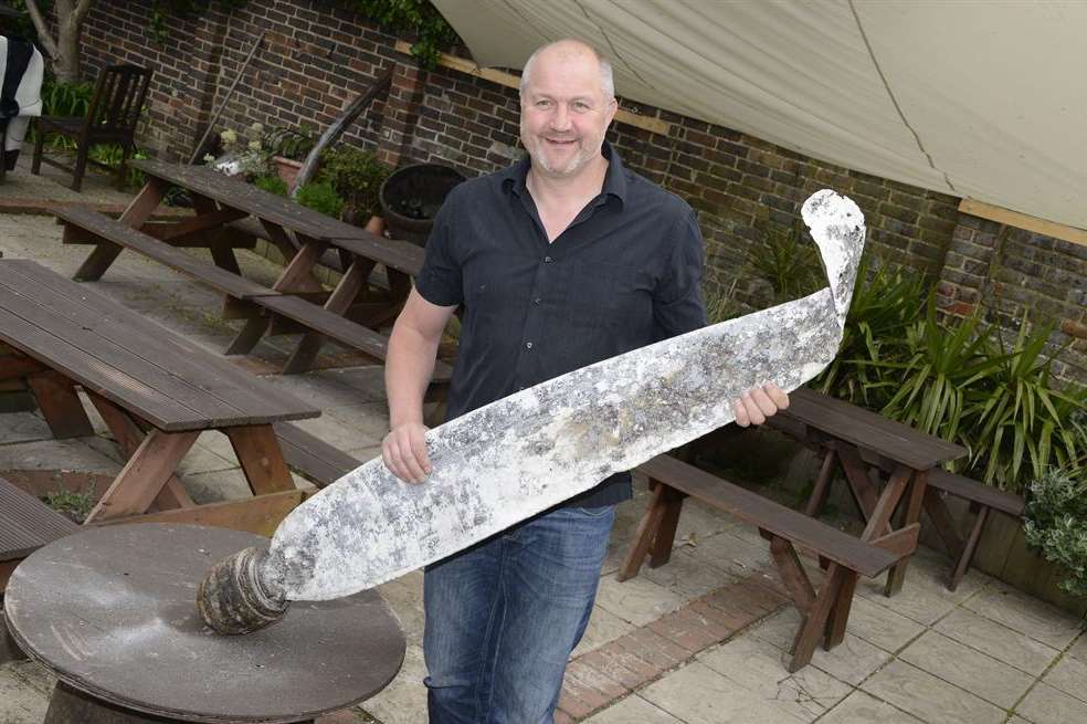Deal Hoy Pub,Landlord Ian Goodban with the Blade from a German Bomber Plane Picture: Paul Amos