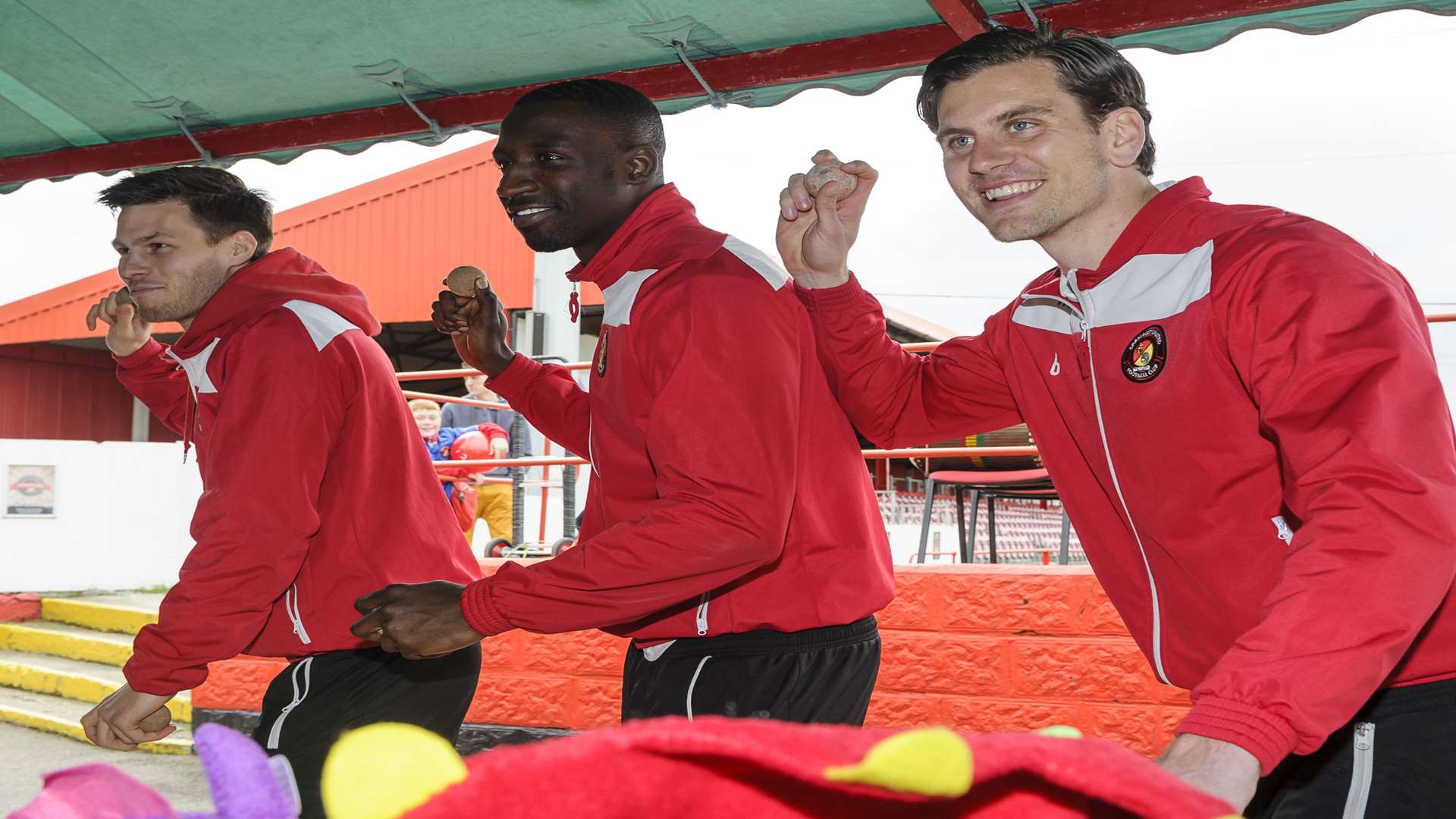 Lining up on Tin Can Alley, first team players from left, Charlie Sheringham, Anthony Acheampong and Tom Bonner. Community day at Ebbsfleet United FC, Stonebridge Road, Northfleet.