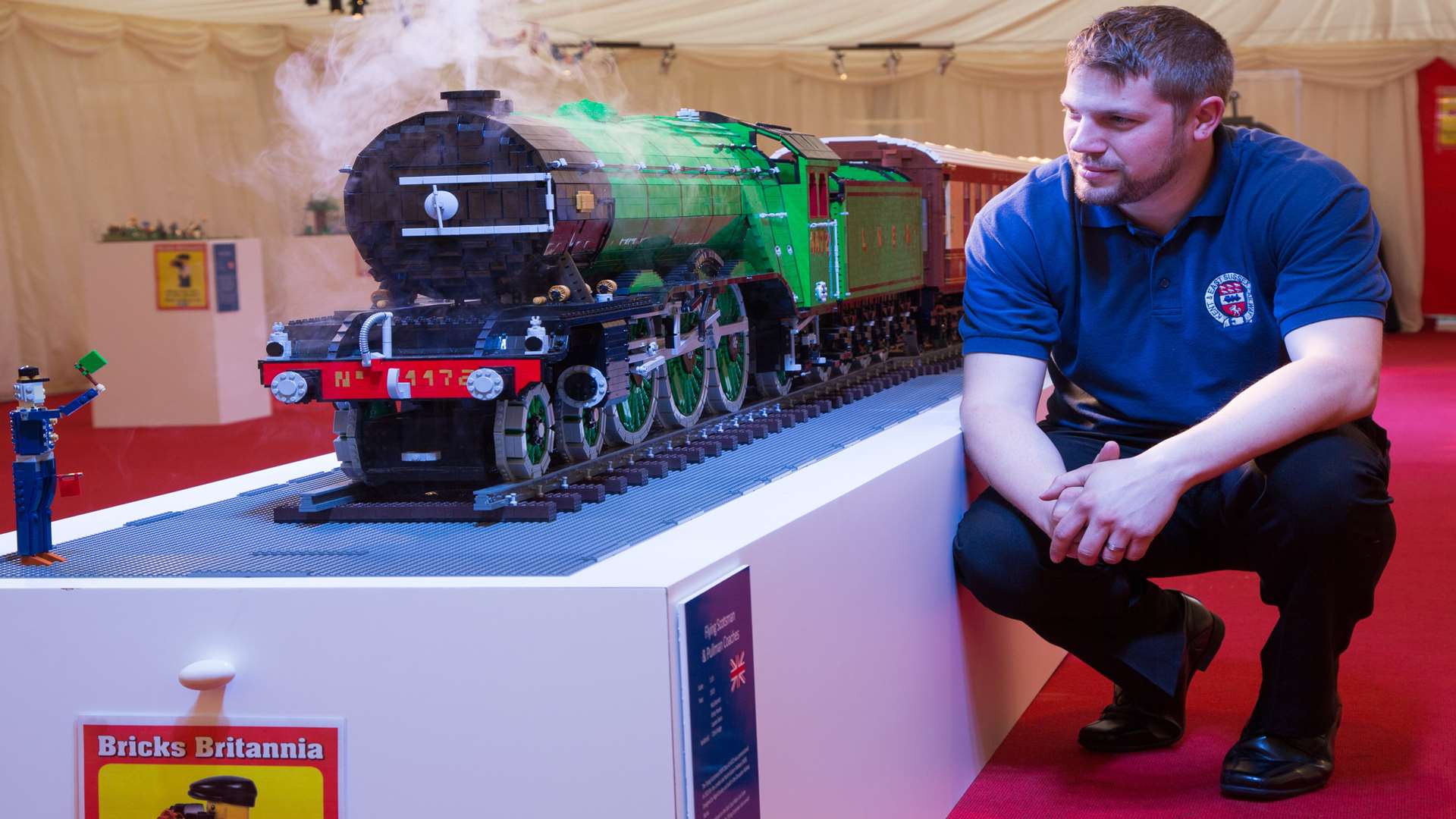 Bricks Britannia organiser Andy Hardy kneeling beside the Flying Scotsman