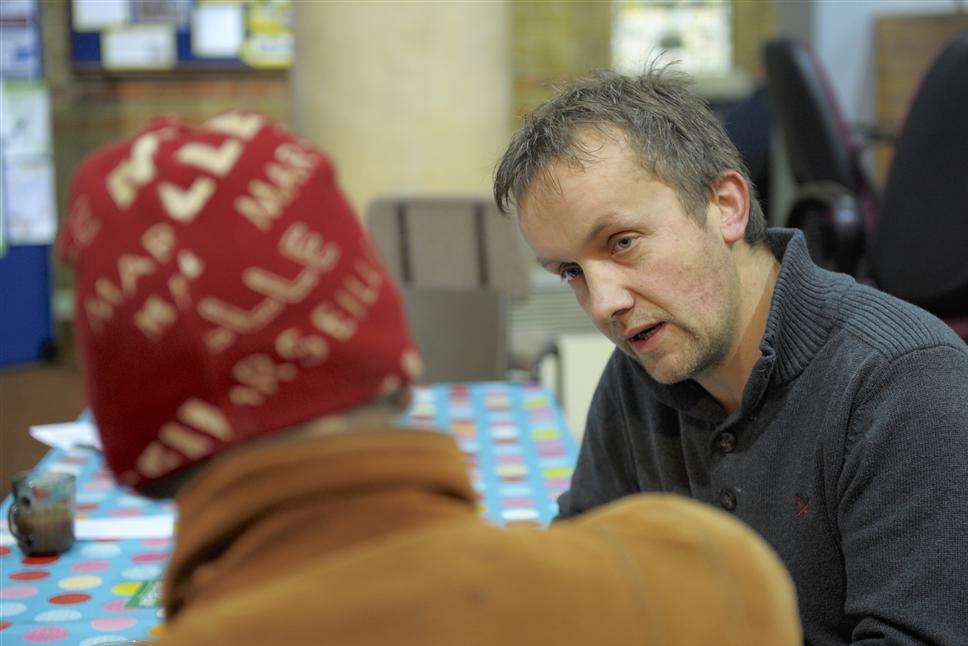 Wym Mauritz talks with a client at the foodbank at St Mark's Church, Gillingham