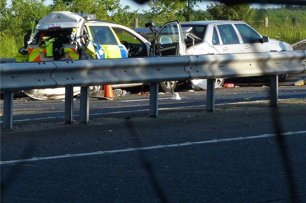The mangled police patrol car which was shunted into a broken-down Volvo on the A256 by an HGV.