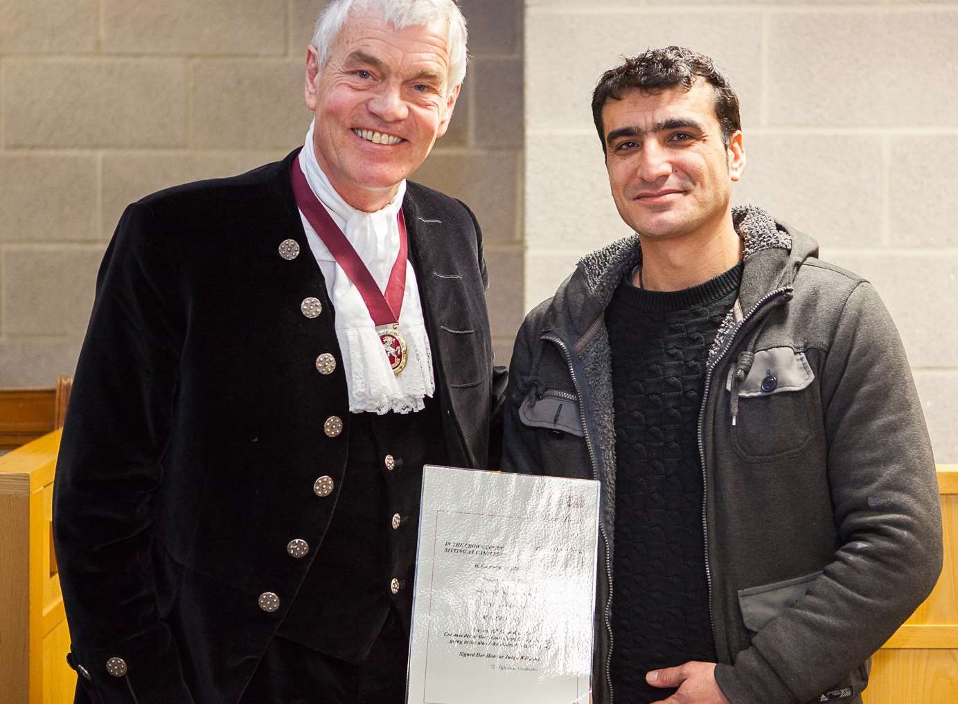 Ali Samivand receiving the award from the High Sheriff