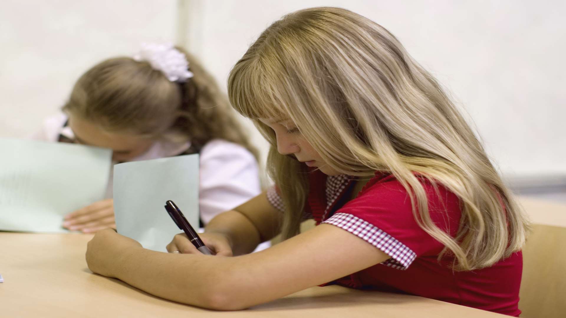 Pupils taking a test. Stock image.