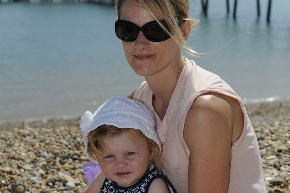 Sara and one-year-old Millie enjoy the weather on Deal beach. Picture: Tony Flashman