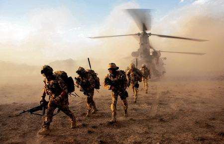 Soldiers from 1 Platoon, A Company of 3 Scots deploy from a Chinook helicopter in the desert