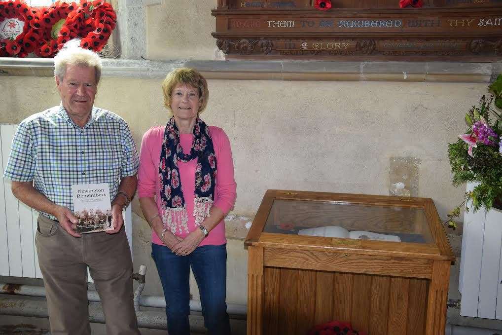Dulcie Mepham and Don Kiff view their grandfather's entry in the Book of Remembrance in Newington parish church