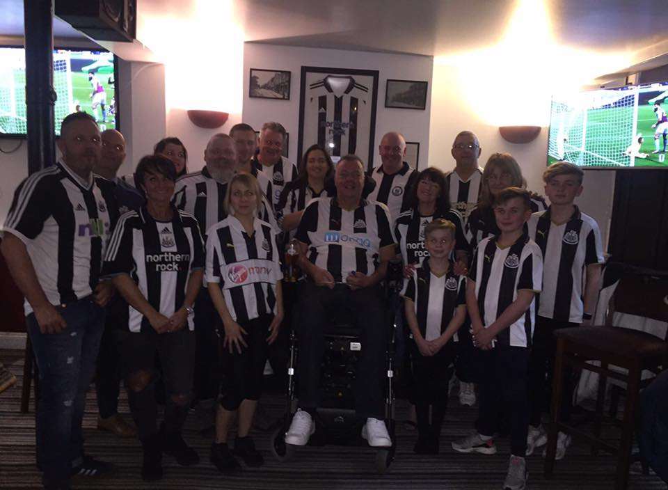 Nigel with some of his family and friends who bought him a signed Alan Shearer shirt at auction.