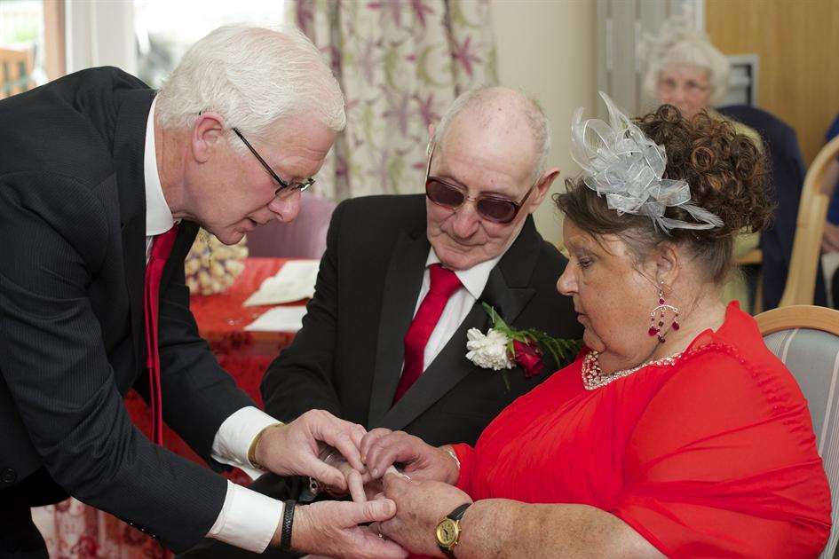Best Man John Adams hands Ted's ring to Gloria.