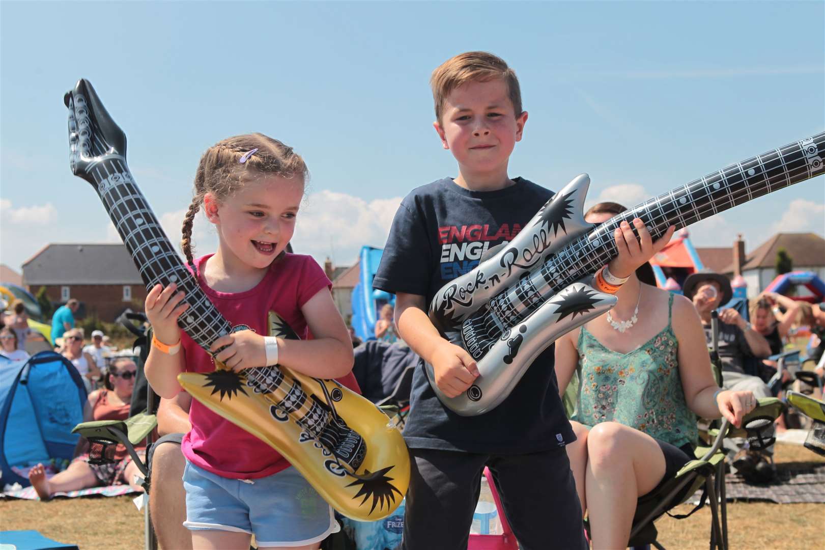 Evie Whittingham, six, with her brother, Harry, eight, play air guitar at Iwade Rock 2018. Picture: John Westhrop