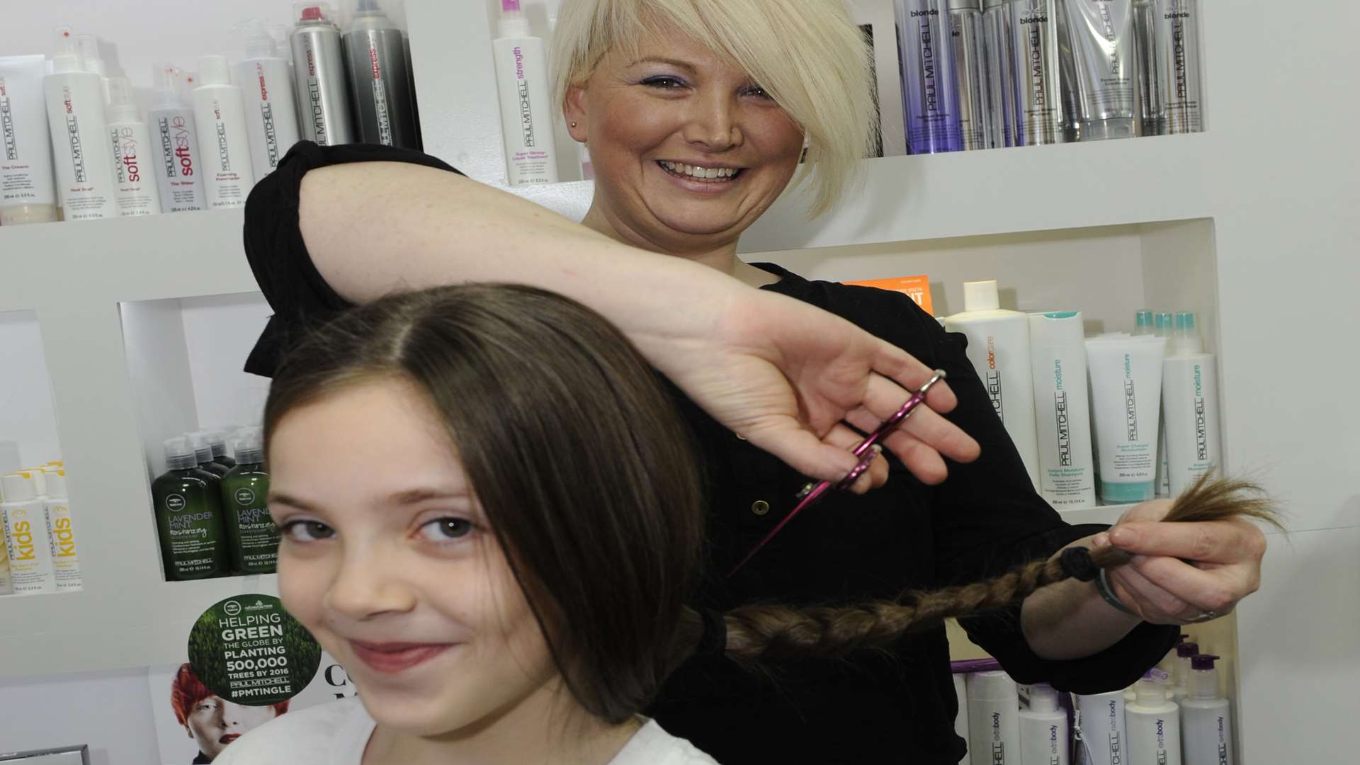 Obsessions Hair, York Street, Ramsgate. Eight-year-old Faith Cunningham has her hair cut for charity. Nicola Clark makes a start cutting Faith's hair