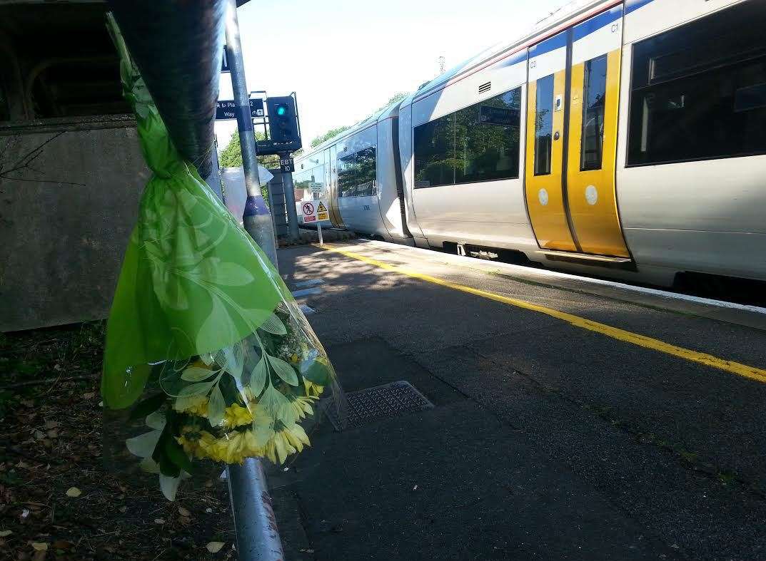 A single bouquet of flowers by the railway line after the tragedy at Chartham train station