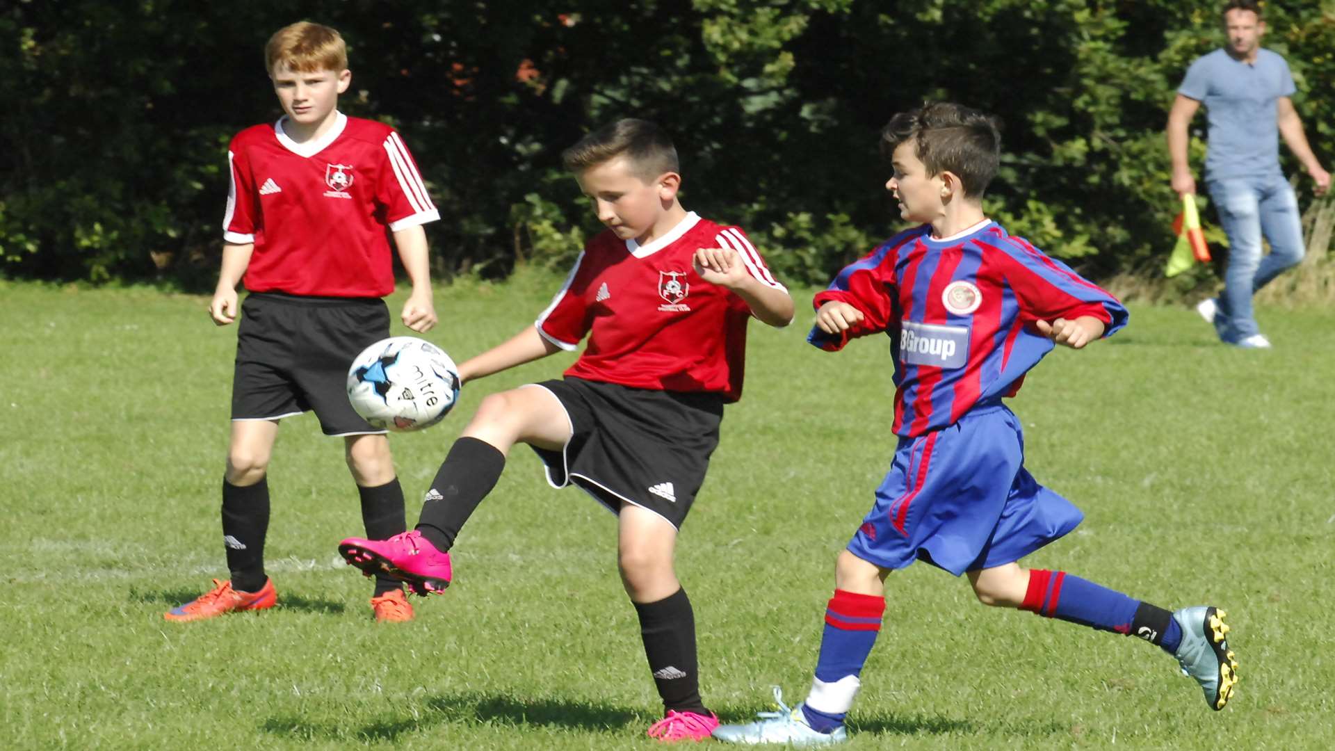 Thamesview Youth under-13s, in red, hold off Woodpecker United in League Cup action Picture: Chris Davey