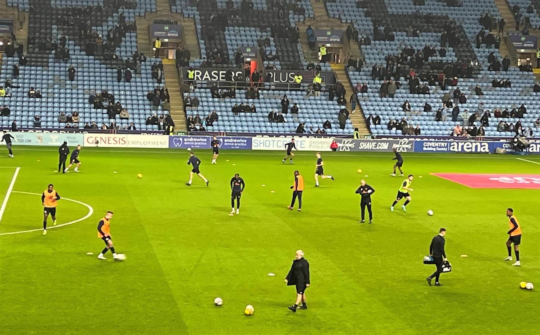 Stones players are out on the pitch warming up.