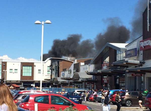 Shoppers are seen staring at the thick smoke cloud. Picture: Jason Brookman