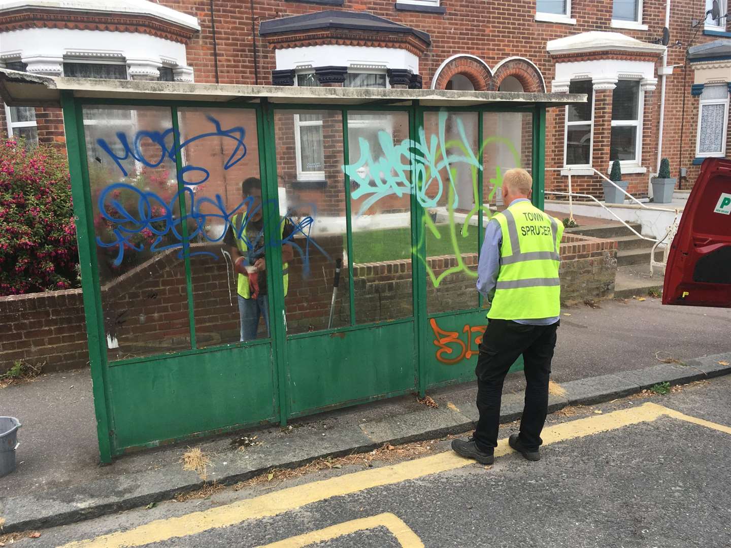 Work begins on the vandalised bus shelter. Picture provided by Peter Wallace
