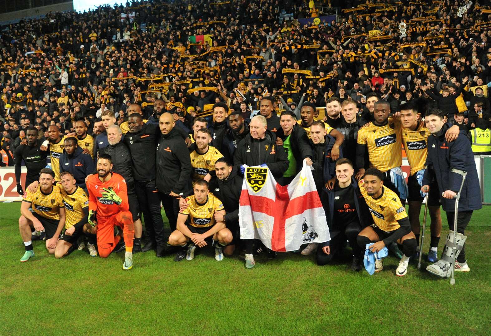 Maidstone players and staff celebrate their magnificent FA Cup run with nearly 5,000 away fans after being knocked out at Coventry on Monday night Picture: Steve Terrell