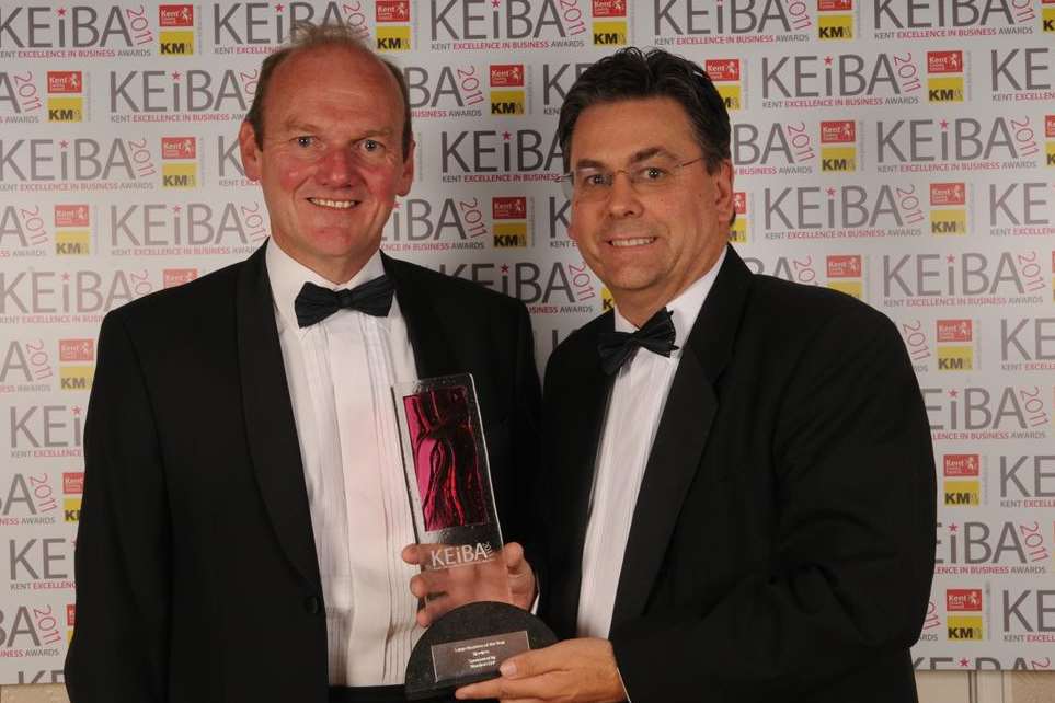 Clive Stevens accepts Reeves' Large Business of the Year award at KEiBA 2011 from Philip Cunningham of Brachers.