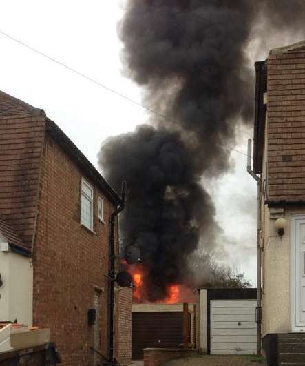 Thick smoke billows from the shed in Cruden Road. Picture: Luka Hanmore