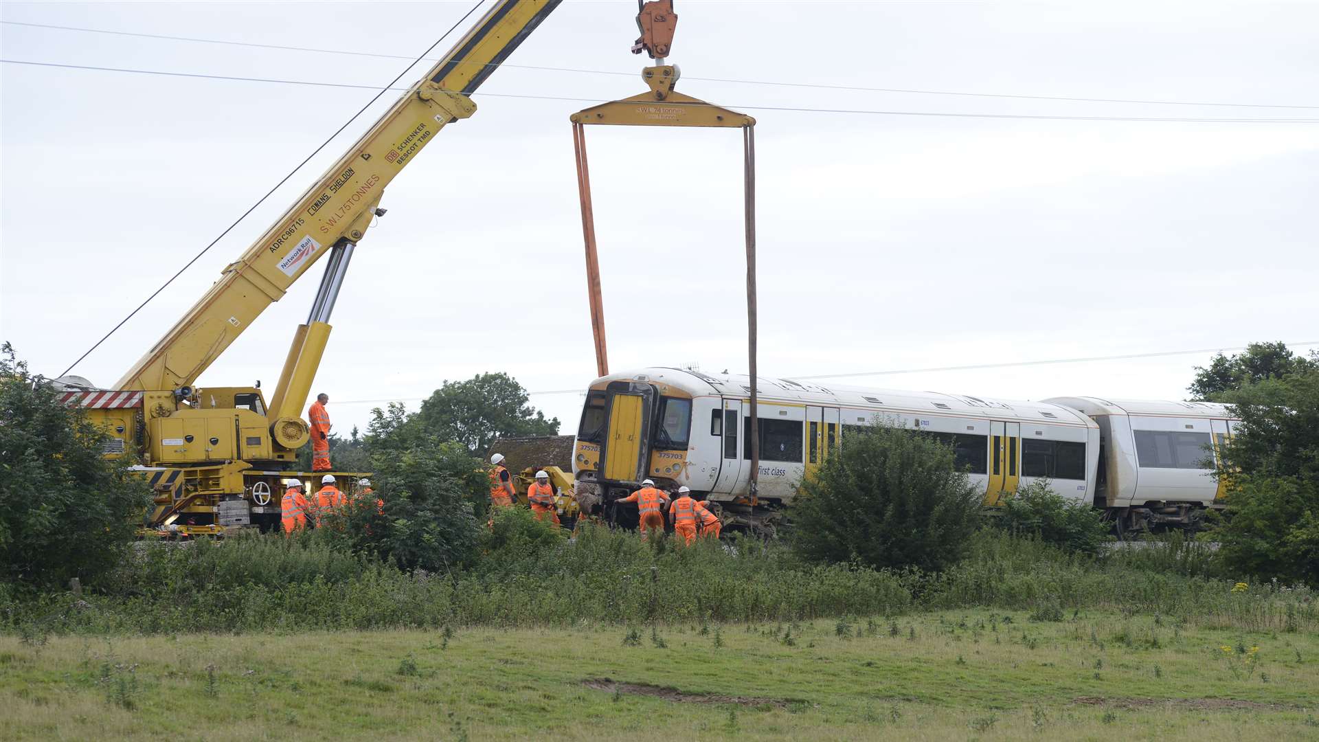 Strops are put on the train to lift it. Picture: Paul Amos.