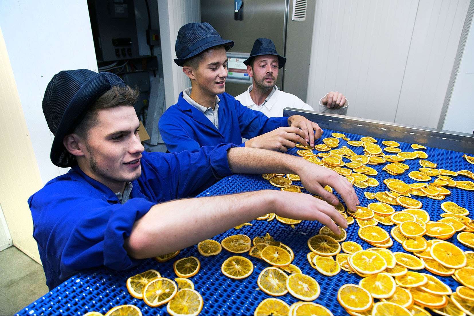 Nim's Fruit Crisps employees, from left, Pawel Janas, Edmunds Zvirgzdins and Myer Trinkwon