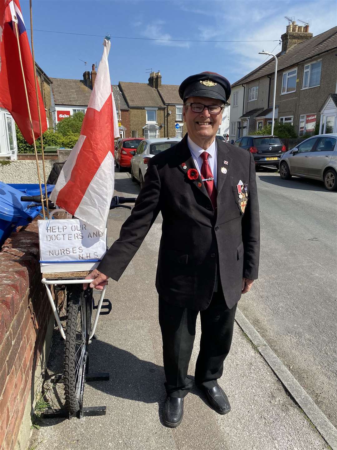 Whistling Postman Dale Howting is still collecting for charity - but now only outside his home in Goodnestone Road, Sittingbourne, because of the coronavirus lockdown. Picture: Katie Palmer
