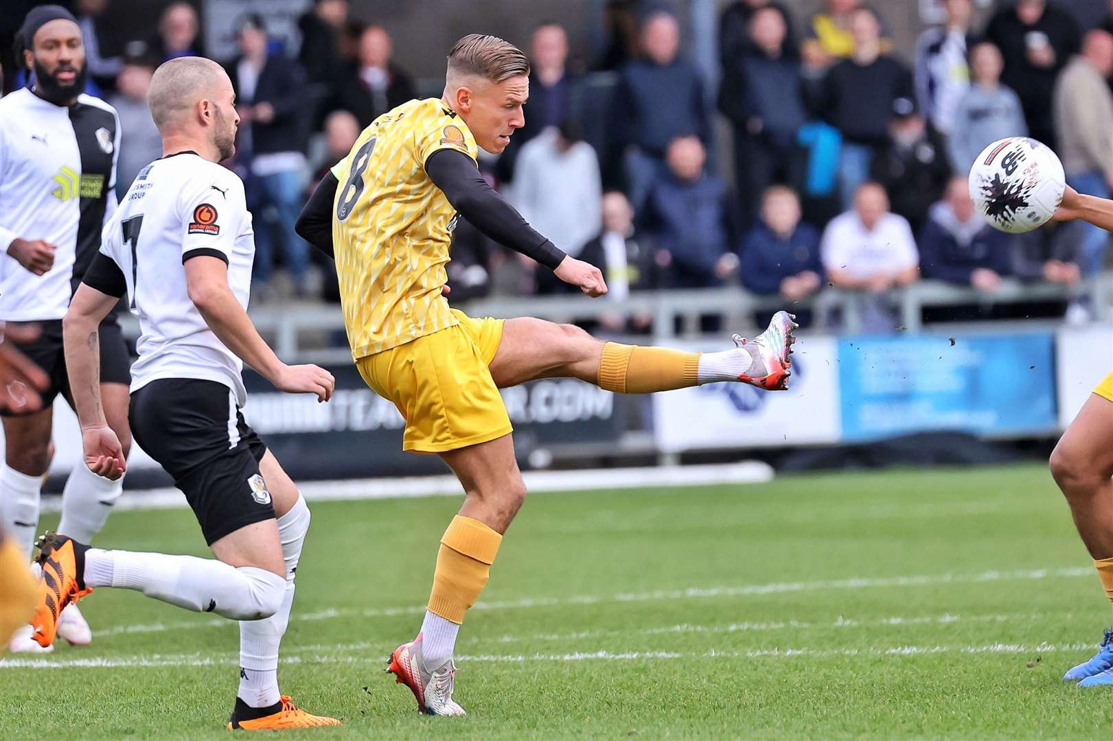 Sam Corne plays the ball forward for Maidstone. Picture: Helen Cooper