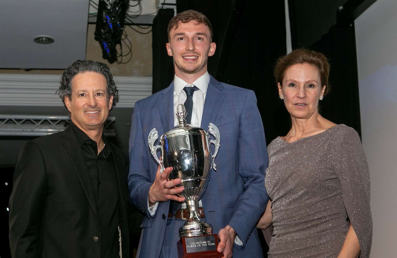 Gillingham's player-of-the-year Conor Masterson with owners Brad and Shannon Galinson Picture: @Julian_KPI