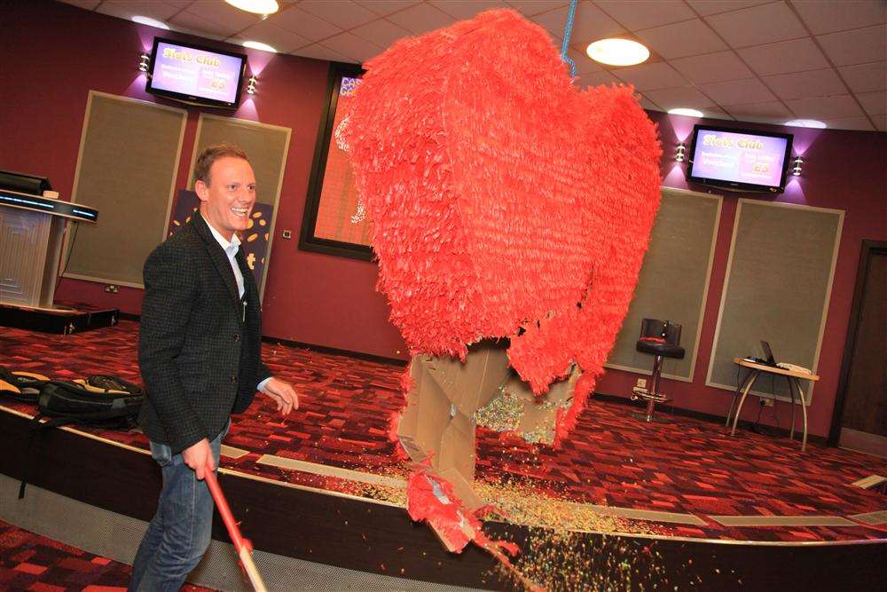 Coronation Street star Antony Cotton hits the giant pinata at Grosvenor Casino in Thanet to mark the launch of Rank's charity partnership with The Carers Trust