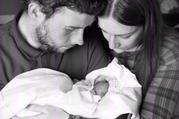 Ryan and Sophie cradle their daughter Lola