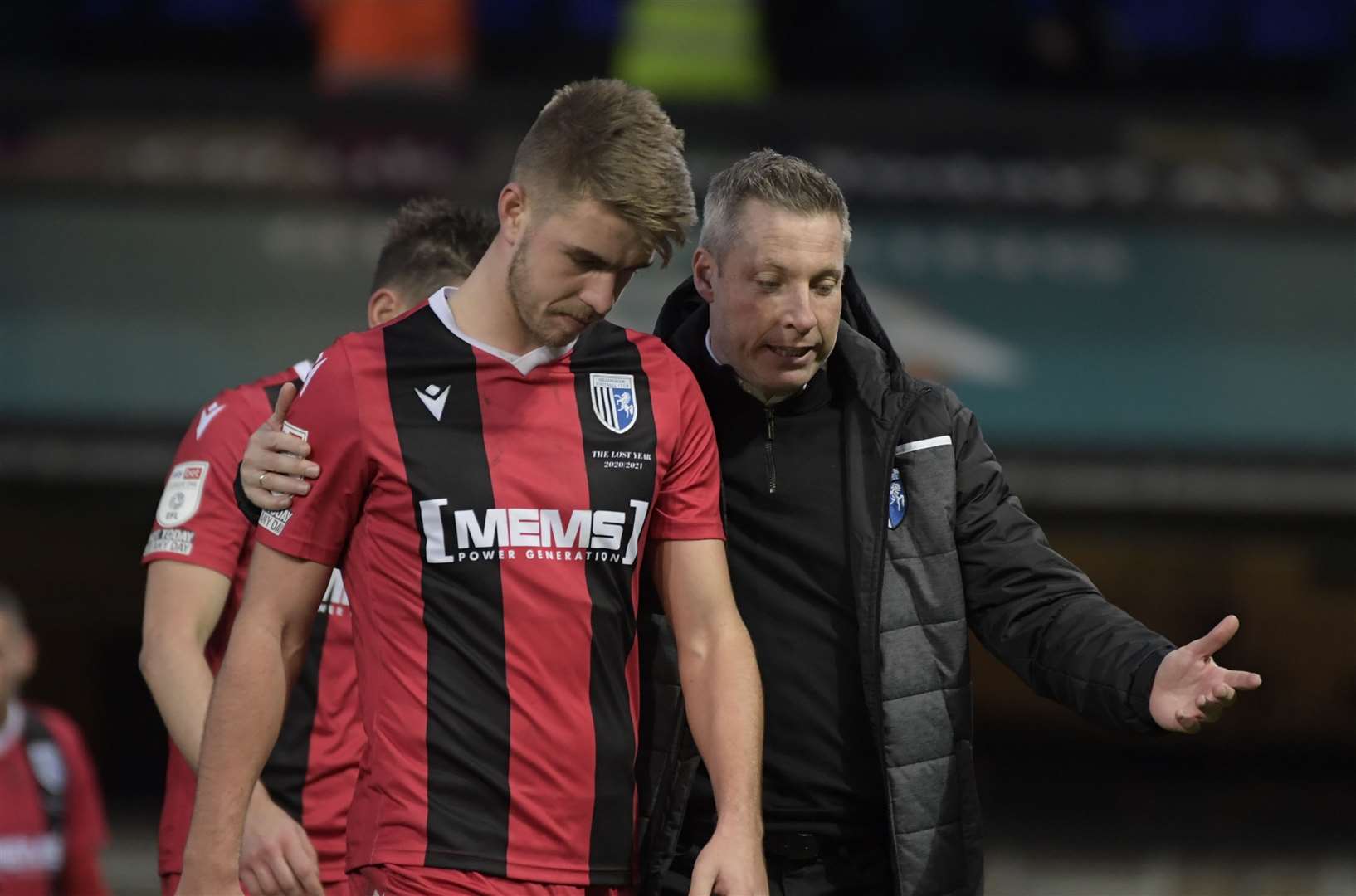 Manager Neil Harris walks off with a dejected Jack Tucker after Saturday's loss Picture: Barry Goodwin