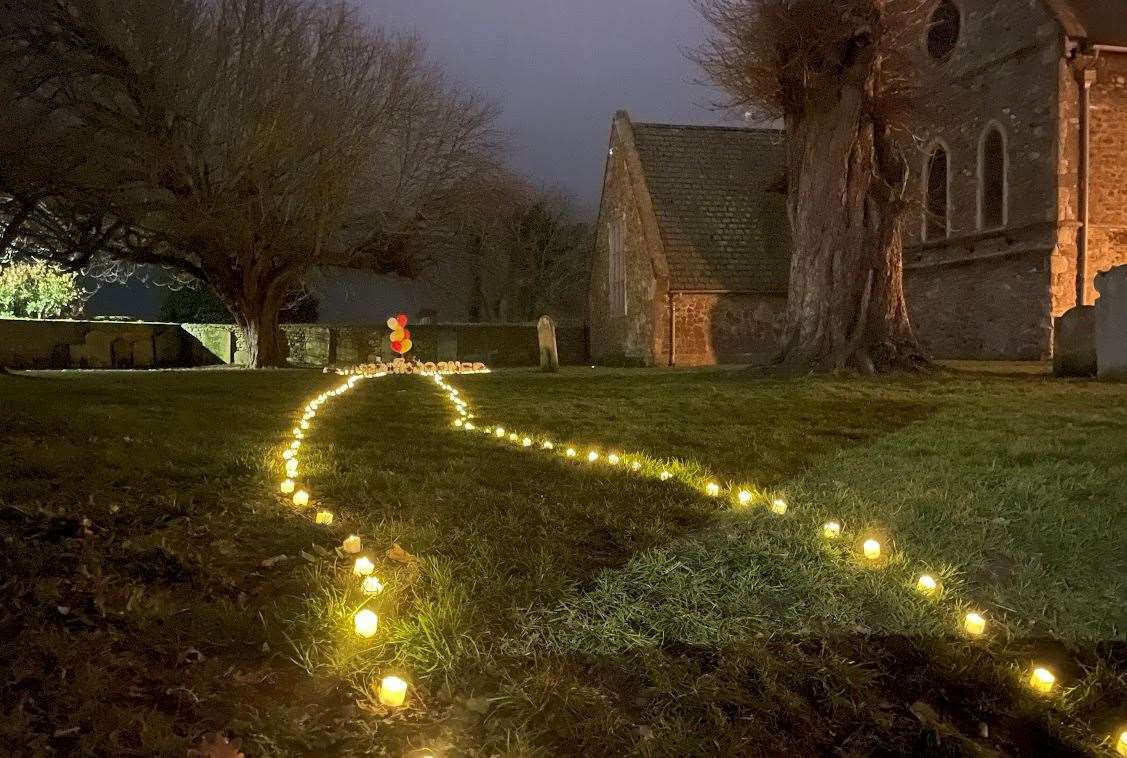A pathway of lights leads through the churchyard to William Brown's final resting place under a chestnut tree. Picture: Gabriel Morris/KMTV