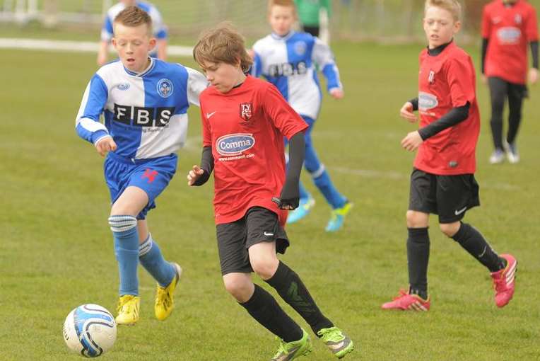 Bredhurst Juniors under-12s (blue and white) give chase against Thamesview Youth in the League Cup second round Picture: Steve Crispe