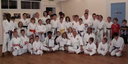 Dean Curruthers receives his black belt and certificate from chief instructor Arthur Wallace