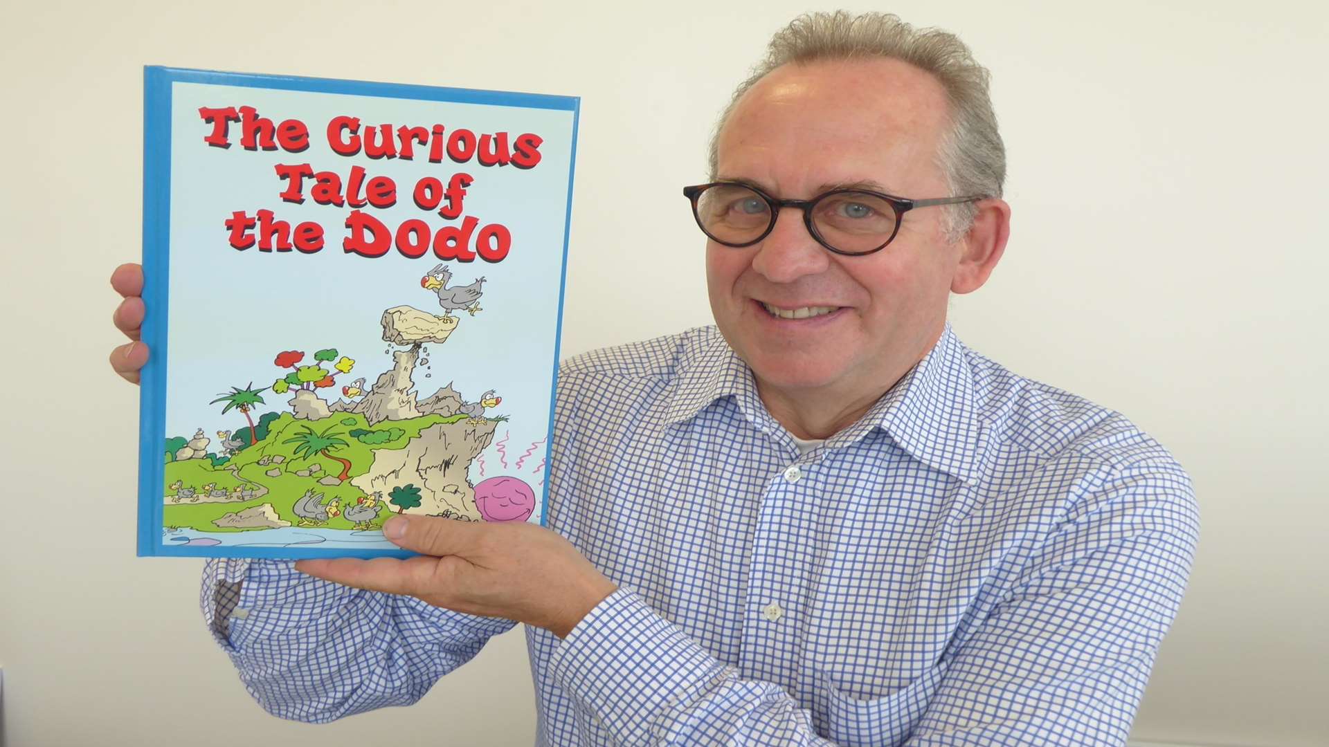 Whitstable author Anthony Cooper, holding his book The Curious Tale of the Dodo, is working with the KM Charity Team to promote World Book Day.